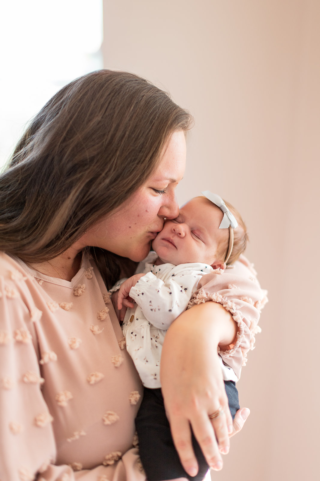 Mom holding newborn baby girl