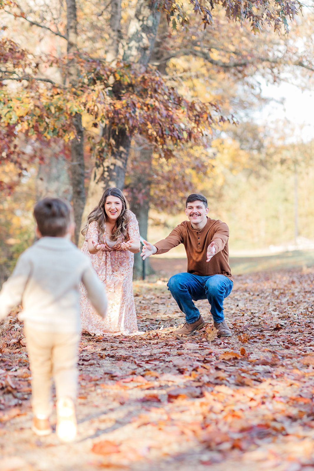 Little Boy running to parents during the fall in Hickory NC