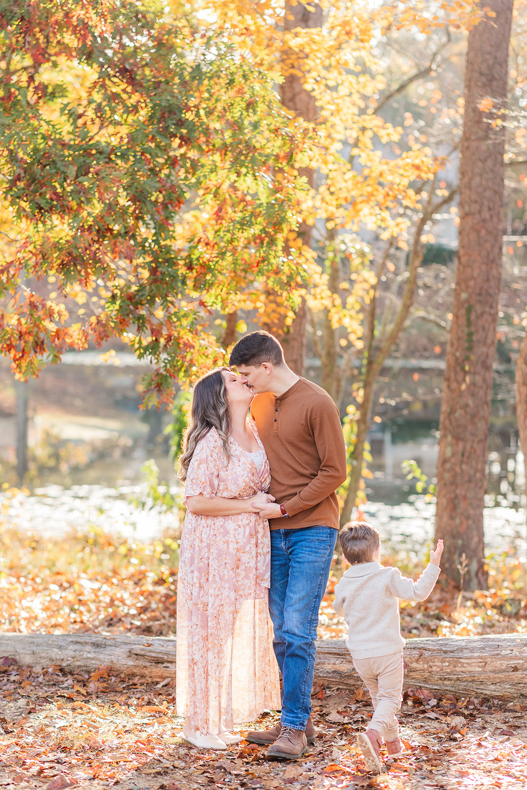 Parents and toddler sharing a joyful moment surrounded by soft morning light