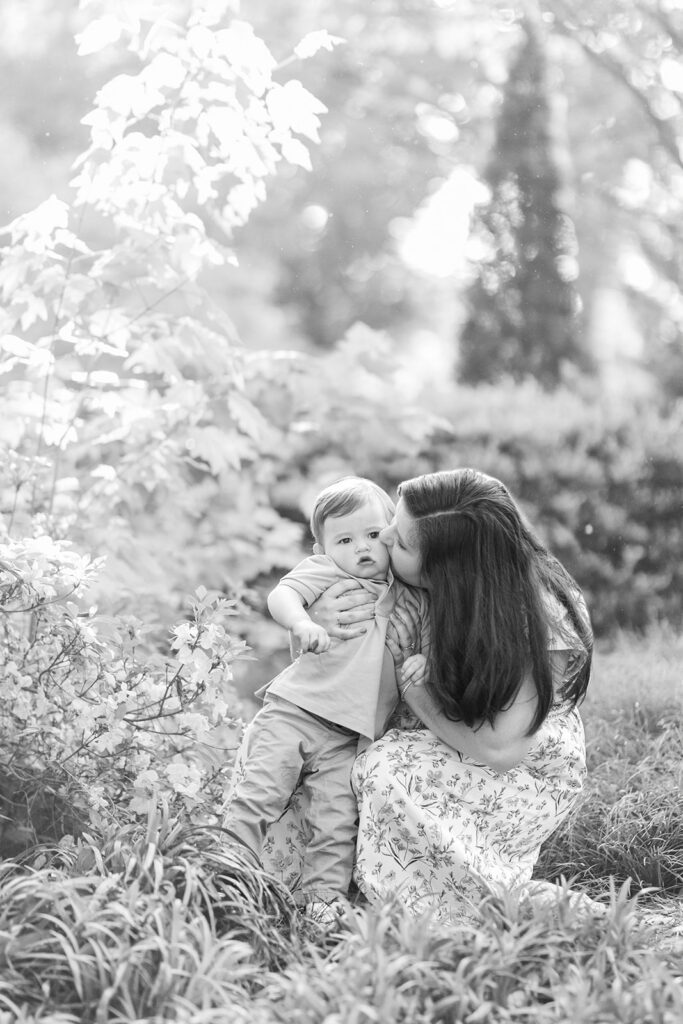 Candid moment of family during spring photo session at Rock Hill’s Glencairn Garden