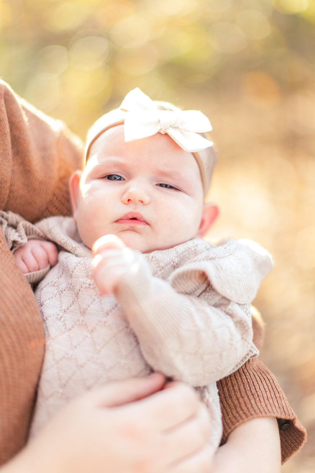 Soft focus of newborn cradled in mom’s arms