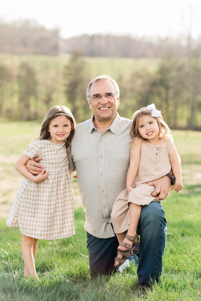 Grandpa with granddaughters during extended family photography in Mocksville
