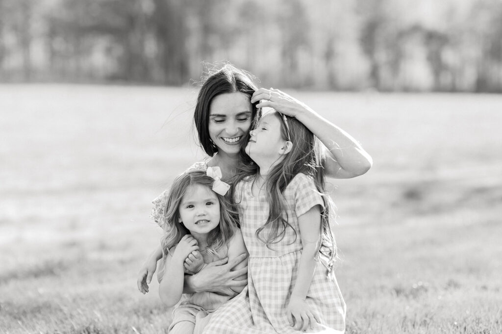 Mother and daughter cuddled up together during extended family photo session in mocksville nc