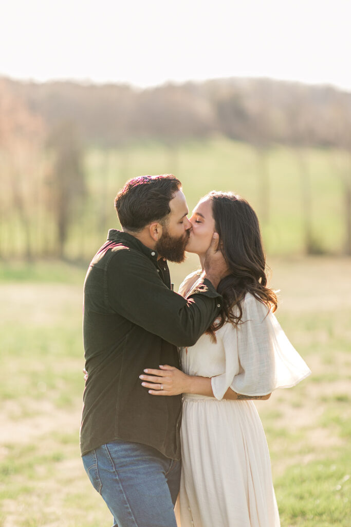 Mom and dad embracing and kissing during family photo session