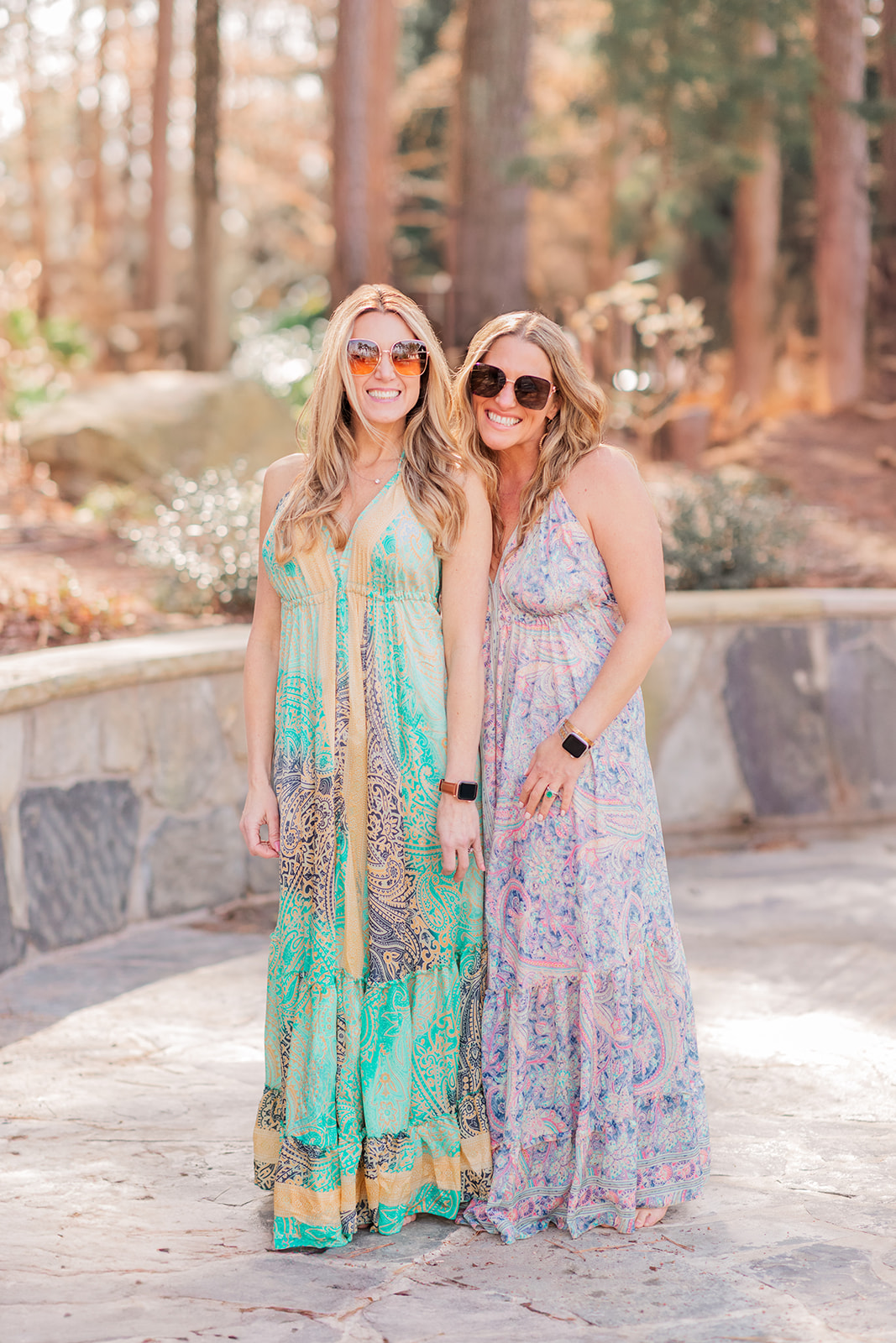 Branding images two girls wearing sunglasses by the pool