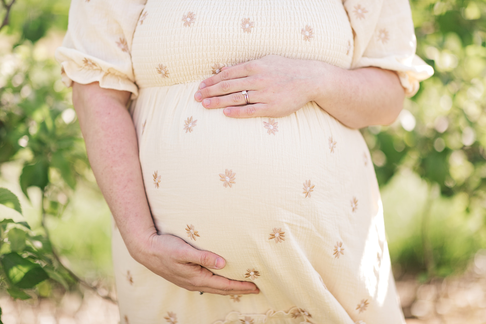 Close-up of baby bump during maternity photo session