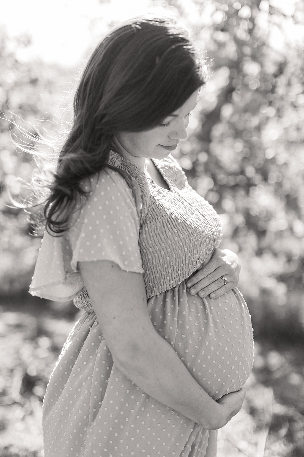 black and white photo of the profile of mom-to-be and baby bump