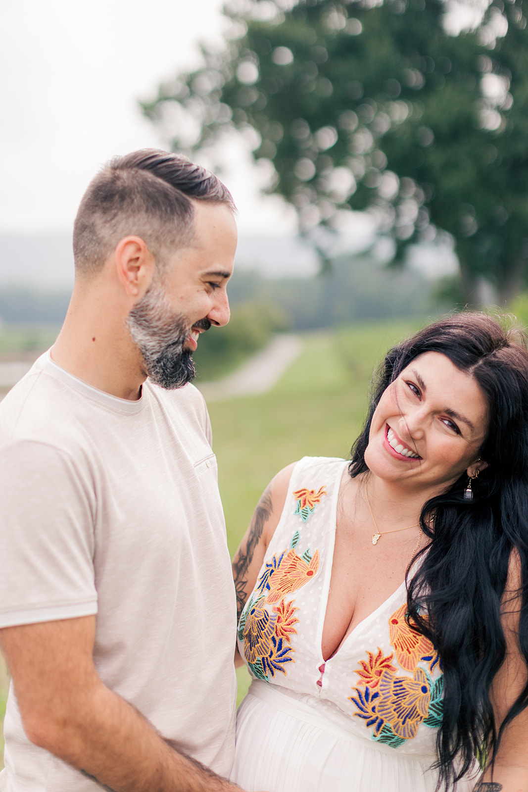 Candid moment of laughter between expecting parents