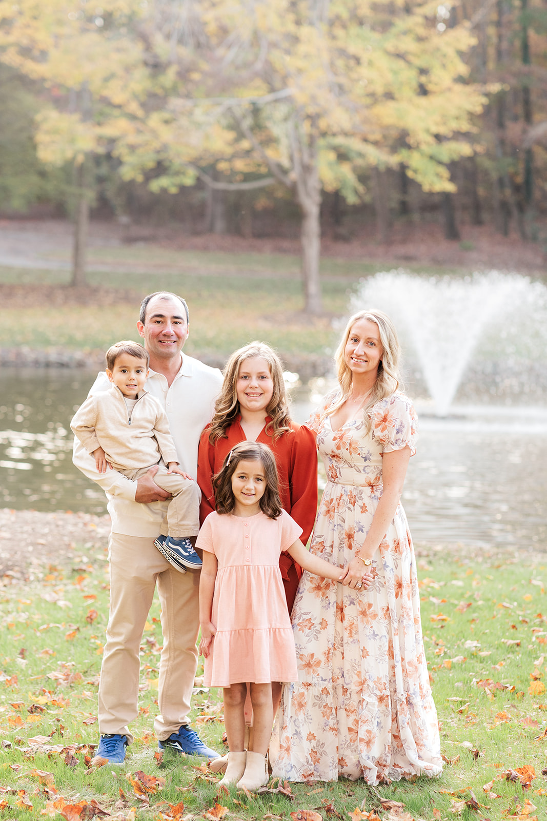Family walking along the pond at MLK Park during fall session