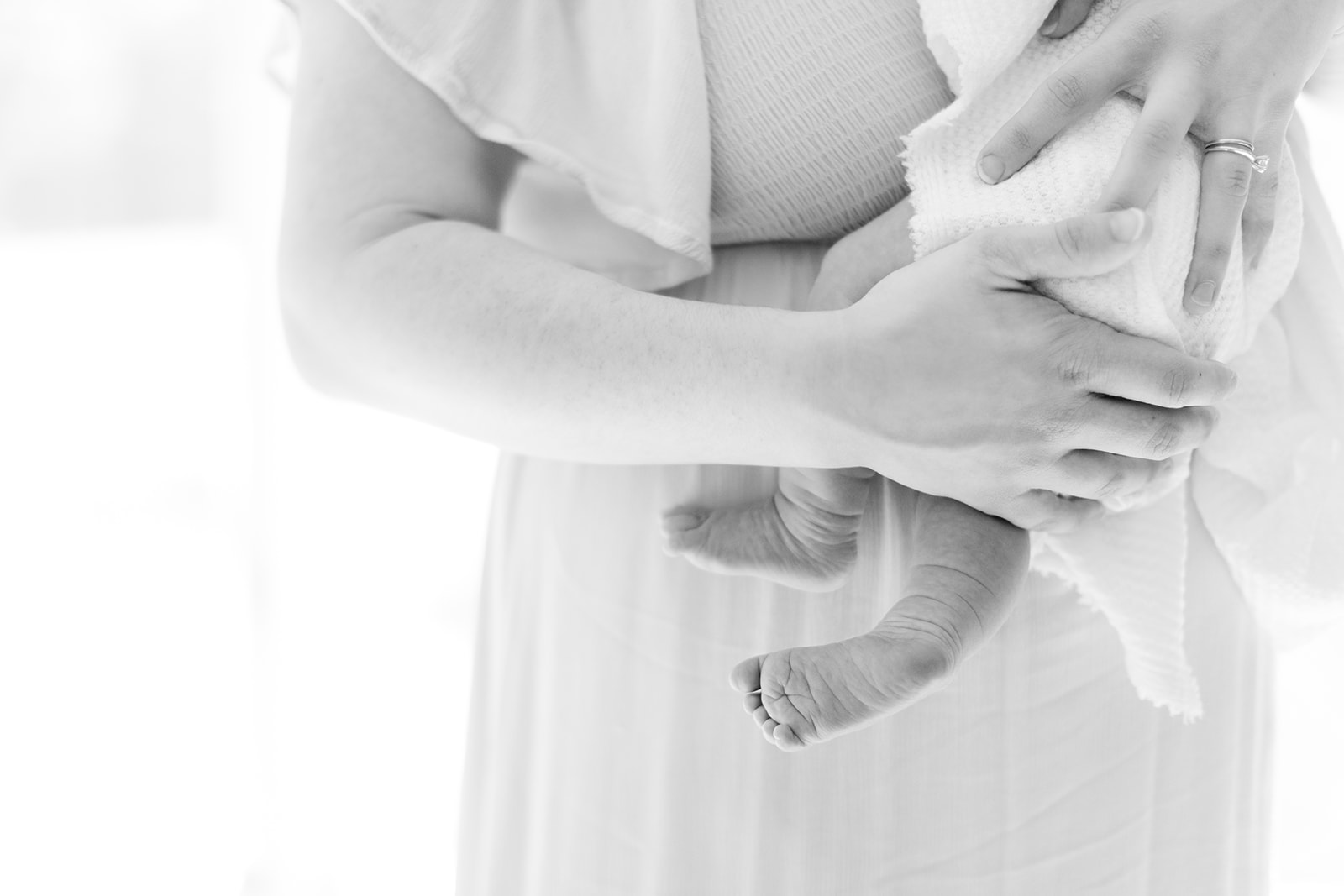 Close-up of newborn baby toes in natural window light