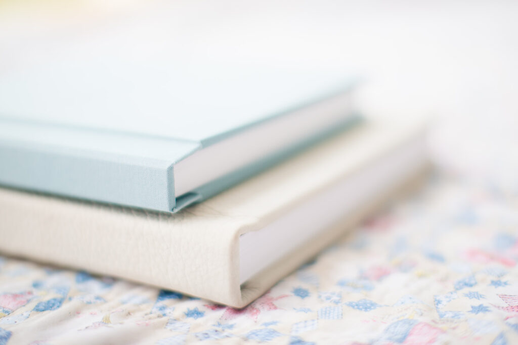 Custom blue linen heirloom album with baby’s first portraits