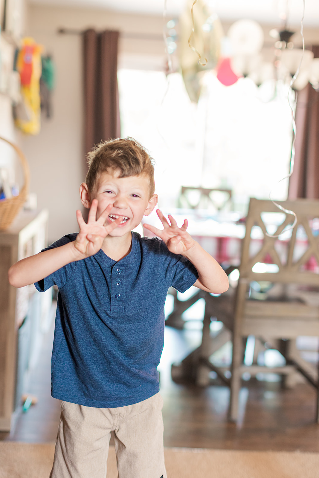 Little boy holding up fingers on his fourth birthday in Statesville, NC