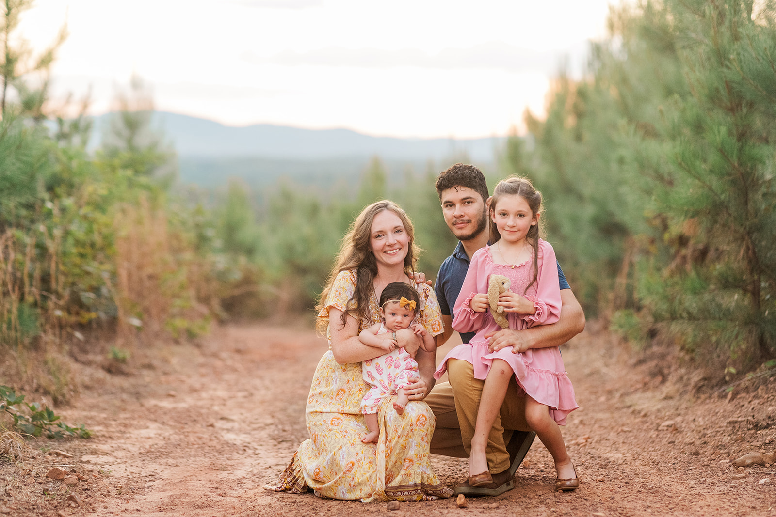 Parents holding their baby boy on their front porch during a family session