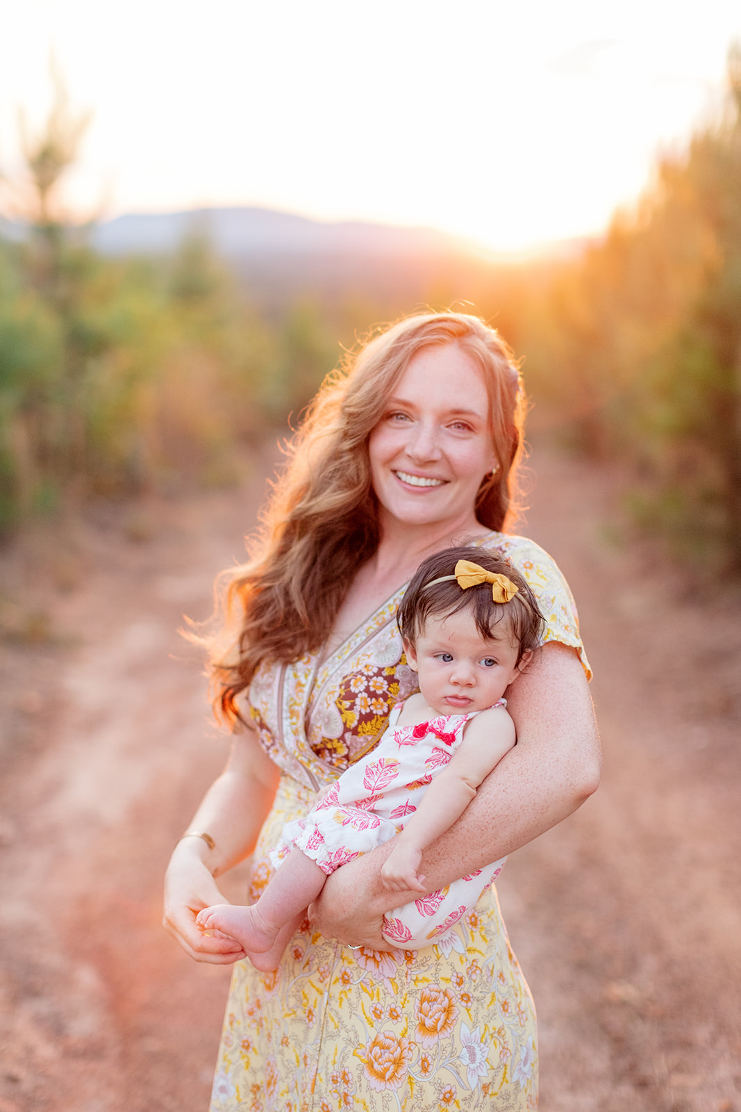 Baby being cradled gently during golden hour family session
