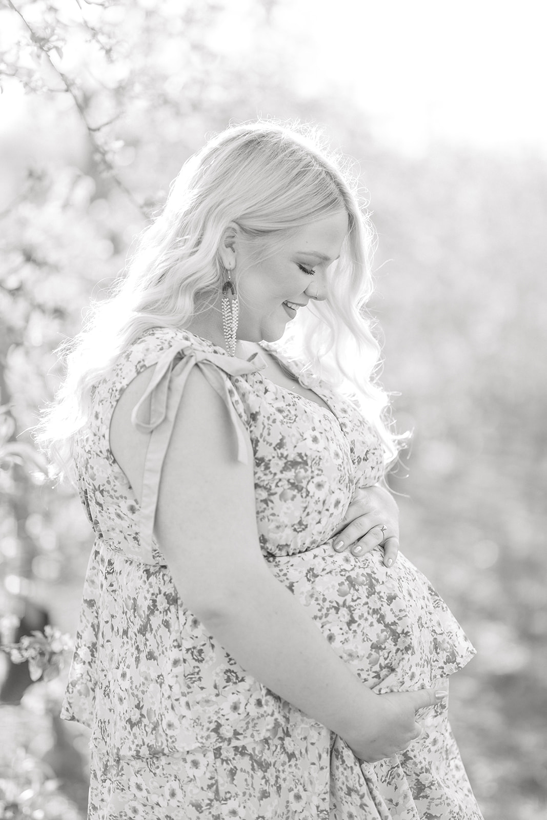 Friend capturing maternity memories in orchard setting