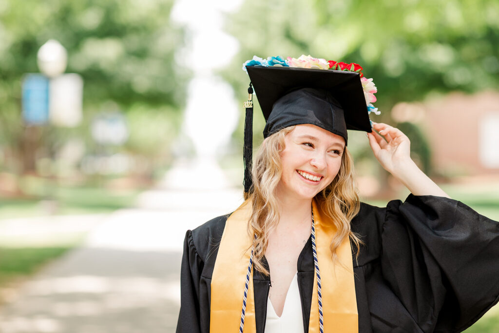 Smiling graduate looking back over shoulder