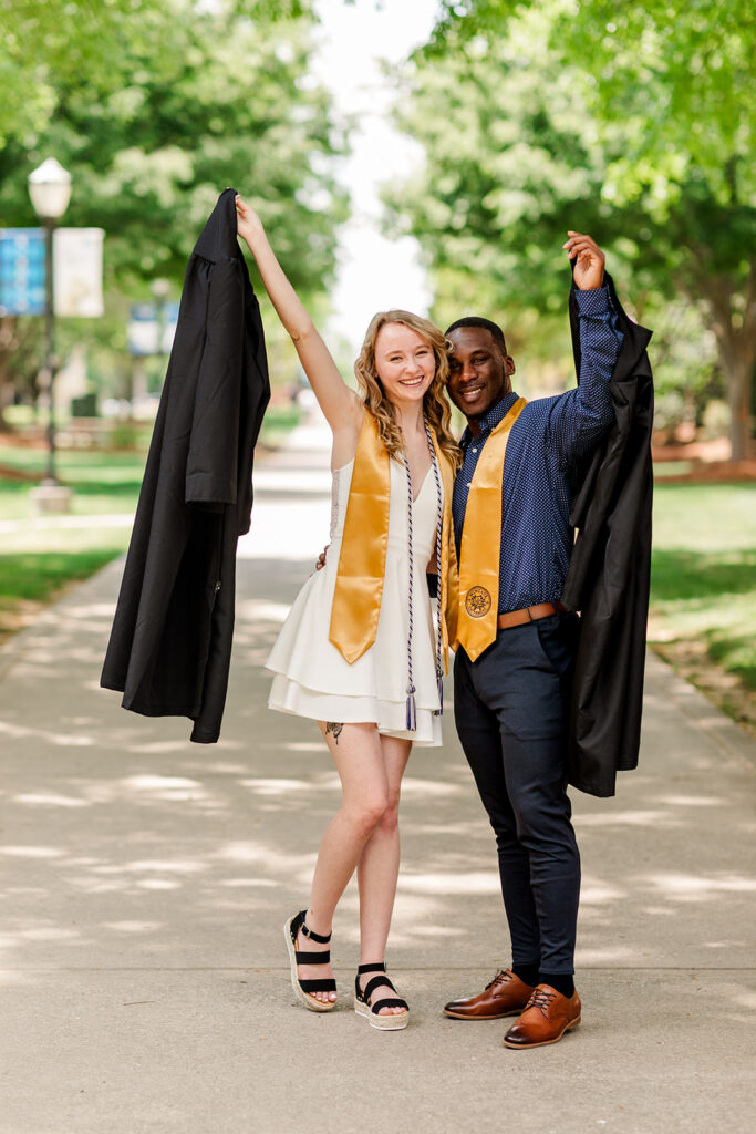 Candid hug between two friends in cap and gown
