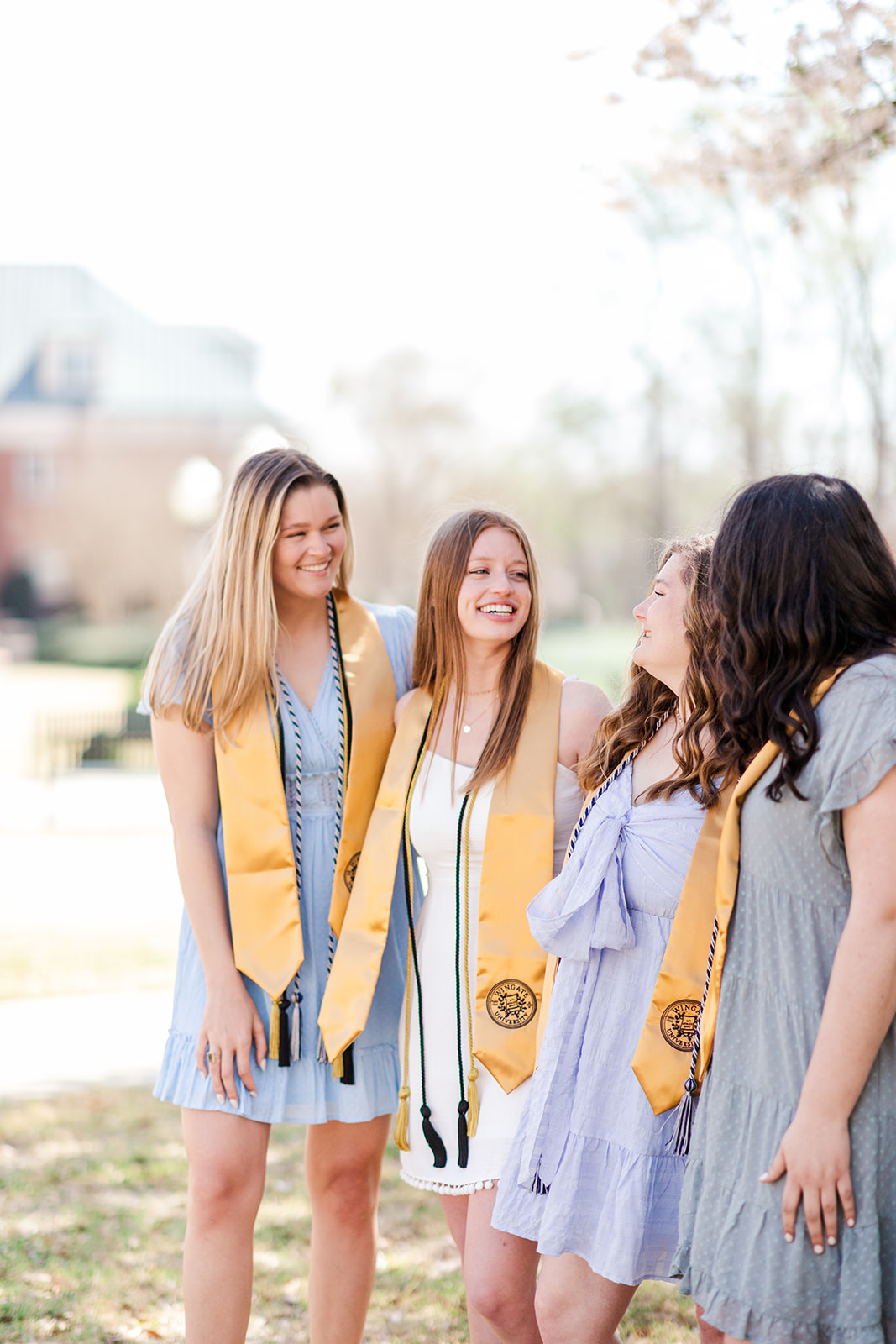 Senior Girls at Wingate University looking at each other during Spring in NC.