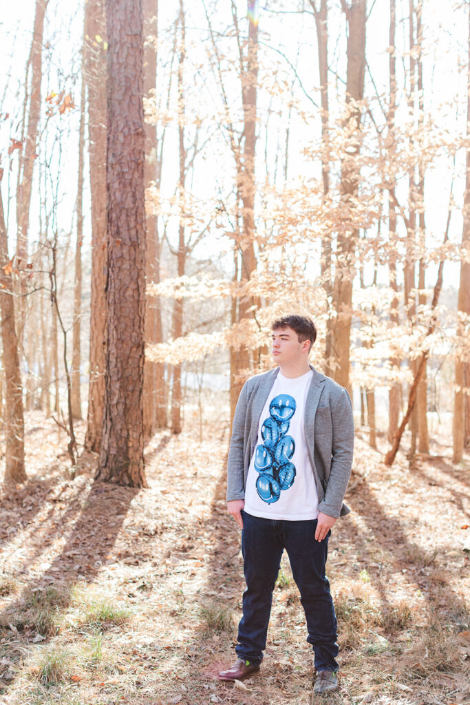 Senior walking on a dirt path, tall trees on both sides
