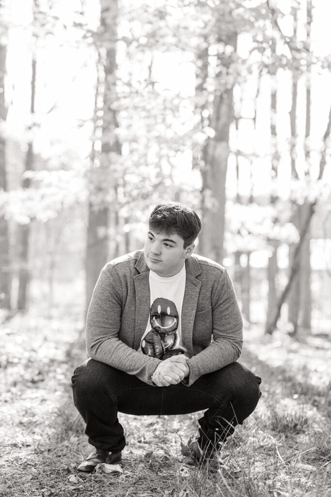 Backlit senior photo during golden hour near the woods