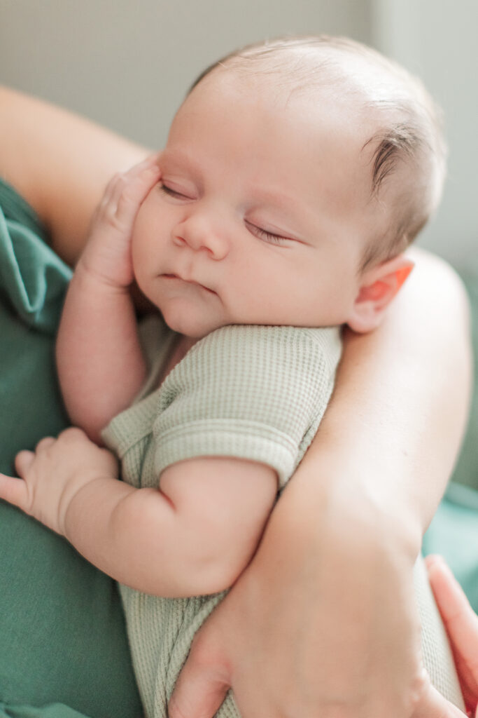 Mother holding newborn son in in-home newborn session near Charlotte, NC.