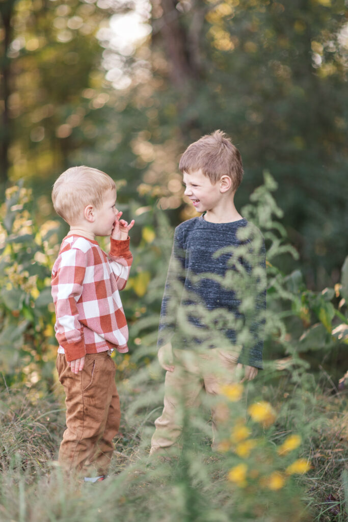 Brothers near Charlotte, NC looking at each other laughing. 