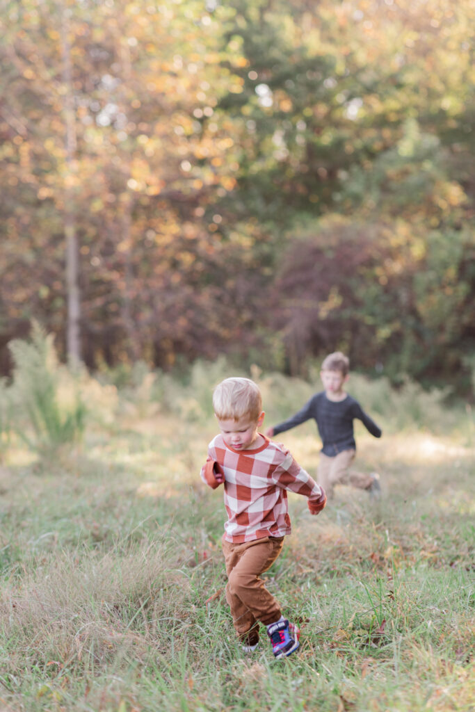 Boys running in the field near Statesville, North Carolina in the fall. 