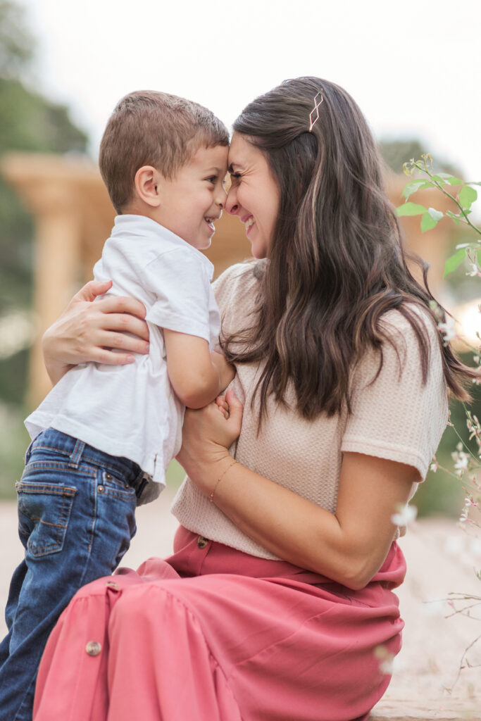 Mom and little boy doing candid eskimo kisses and laughing in Taylorsville, NC at Fleurish Greenhouse. 