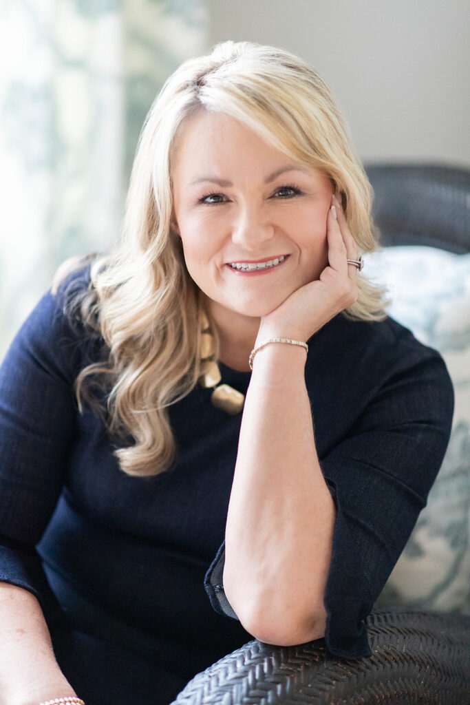 Headshot of a woman looking at camera holding face in her hands with professional headshot photographer in Mooresville, NC. 
