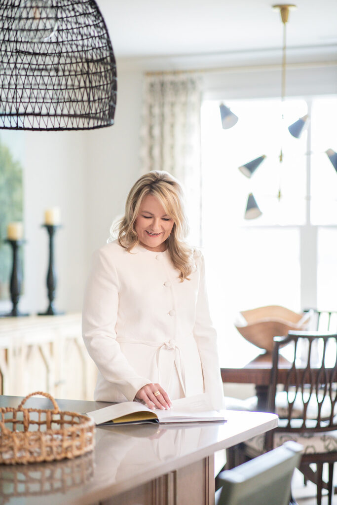 Woman looking at instruction book smiling during headshot photos near Troutman, North Carolina. 