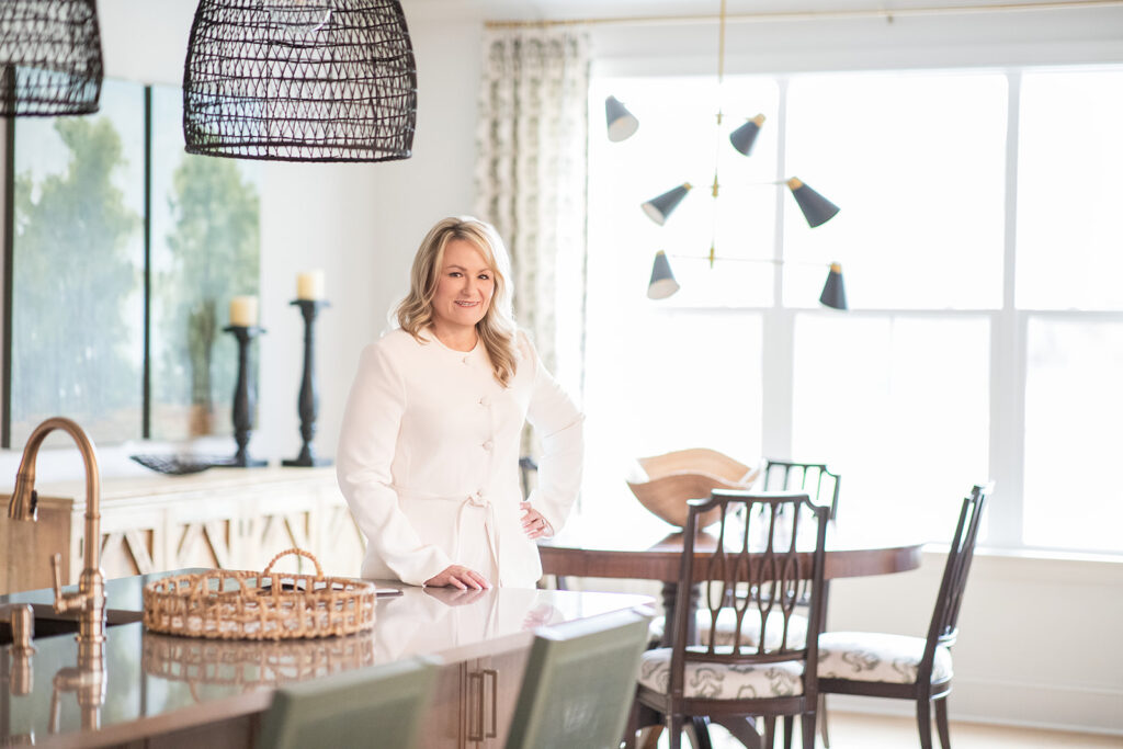 Headshot of a realtor in a beautiful kitchen looking at camera during branding session with Hannah Elizabeth Photography. 