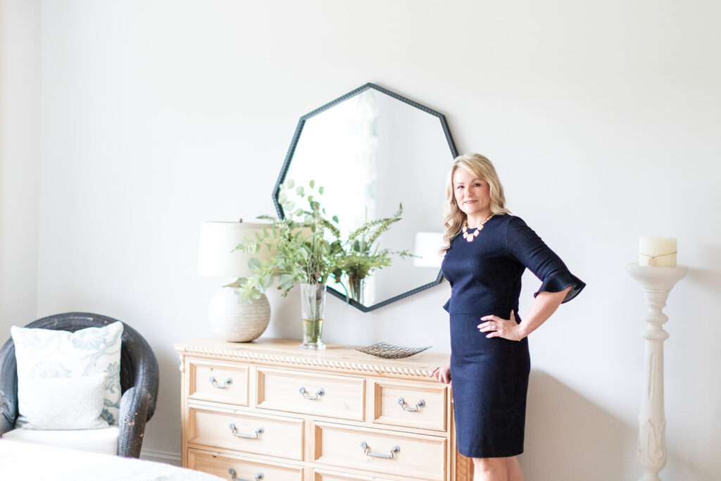 Headshot of Realtor Roxanna Levan in a beautiful home in front of a dresser and mirror with professional headshot photographer in Mooresville, NC. 